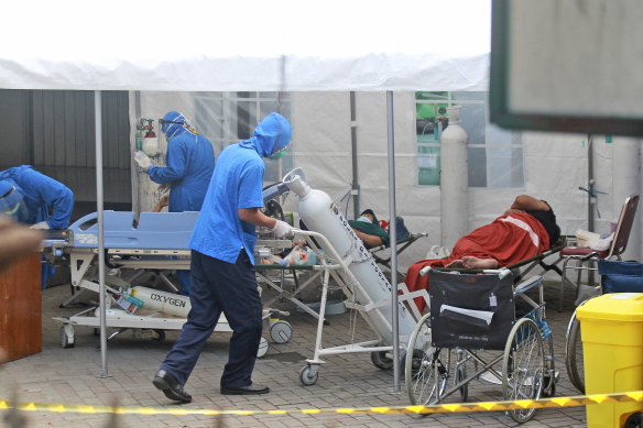 A medical worker wheels an oxygen tank to be used to treat patients at an emergency tent erected to accommodate a surge in COVID-19 cases, at Dr. Sardjito Central Hospital in Yogyakarta on Sunday.