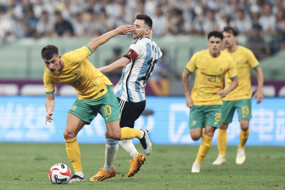 Ajdin Hrustic peels away from Argentina’s Lionel Messi during Australia’s friendly in Beijing last year.