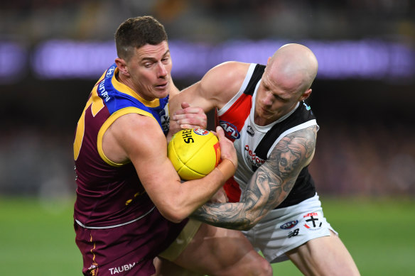 Dayne Zorko and Zak Jones grapple for the football.