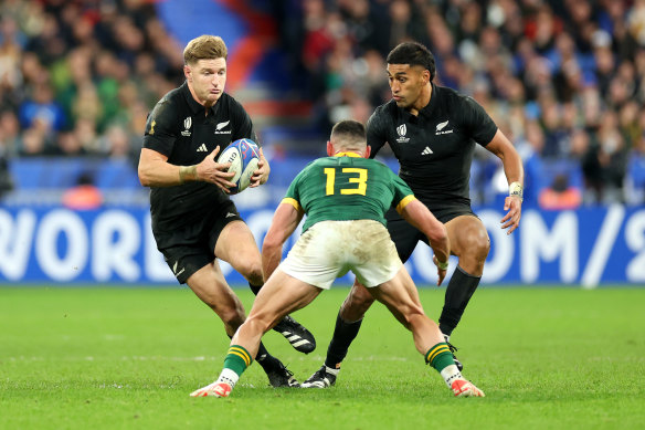 Jordie Barrett runs the ball up.