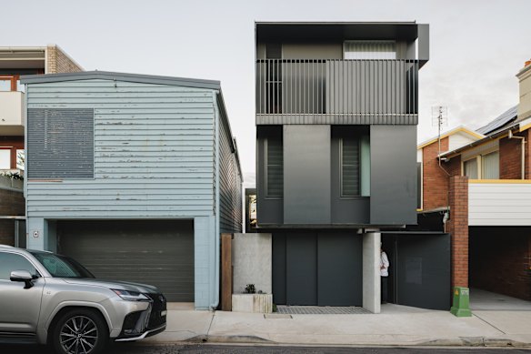 Away from the ocean view, the house’s (right) two-level black steel facade adds a sense of mystery.