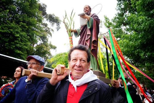 Community members carry the statue of St Paul through Baromi Park in Mirboo North.