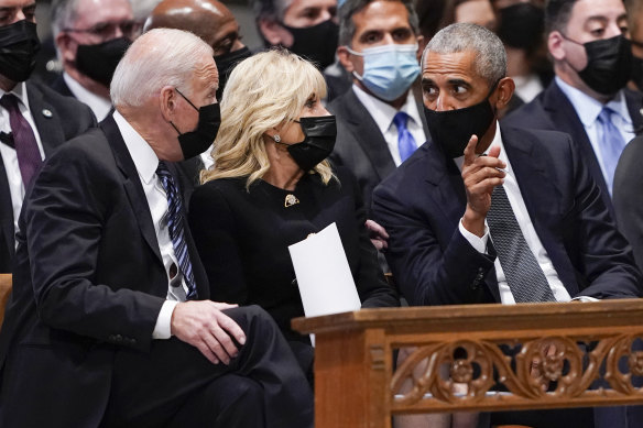 President Joe Biden and first lady Jill Biden talk with former president Barack Obama before the funeral began. 