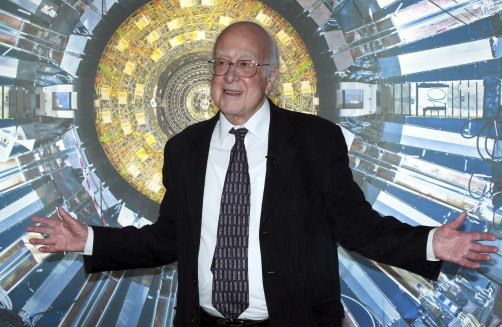Professor Peter Higgs in front of a photograph of the Large Hadron Collider at the Science Museum, London, 2013.