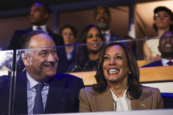 Second gentleman Doug Emhoff and Democratic presidential nominee Vice President Kamala Harris listen during speeches at the Democratic National Convention.