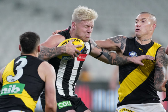 Dustin Martin, right, tackles Jordan De Goey during round two. 