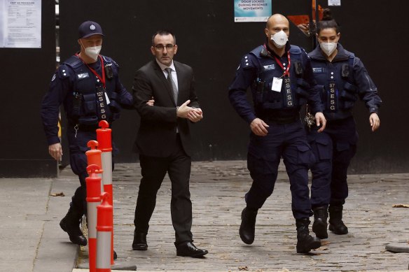 Jason Roberts is escorted from the Supreme Court after being found not guilty of the murders.