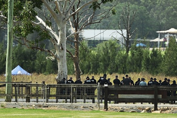 A NSW police officer searches Pitt Town Bottoms Road near Lynwood Golf Club.