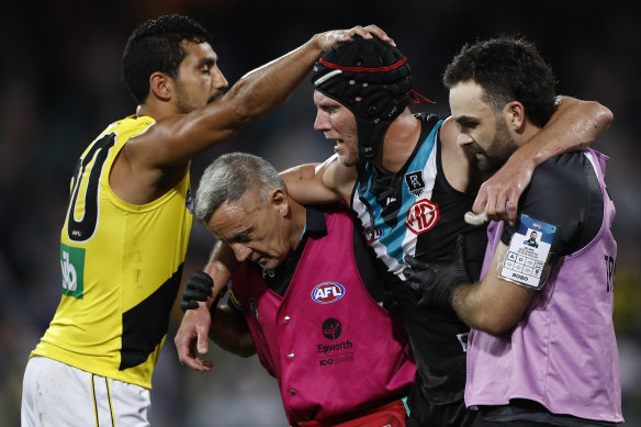 Richmond's Marlion Pickett acknowledges Port's Brad Ebert as the Power veteran leaves the field with concussion.