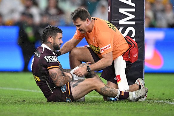 Adam Reynolds gets assessed by a trainer after scoring for the Brisbane Broncos against the Canterbury-Bankstown Bulldogs.