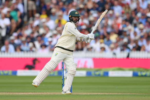 Nathan Lyon plays a shot despite his injury.