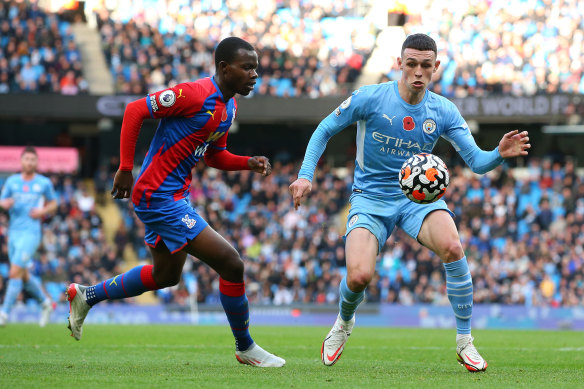 Phil Foden of Manchester City controls the ball ahead of Tyrick Mitchell of Crystal Palace.