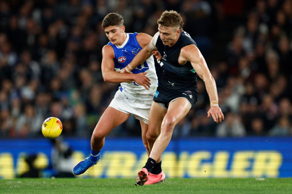 Patrick Cripps of the Blues and Harry Sheezel of the Kangaroos compete for the ball.