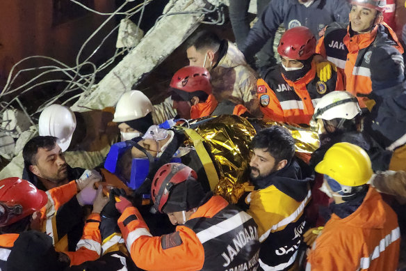 Rescue workers pull out Naime Sakar from a collapsed building in Adiyaman, southern Turkey, on Monday.