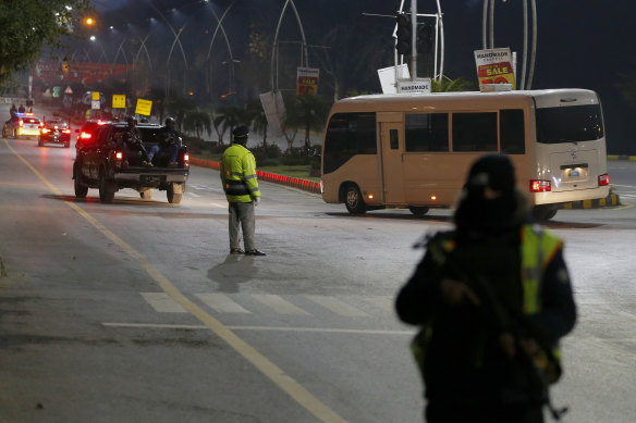 Pakistani security forces escort a convoy of vehicles carrying the Australian team toward their hotel upon their arrival in Islamabad on Sunday.