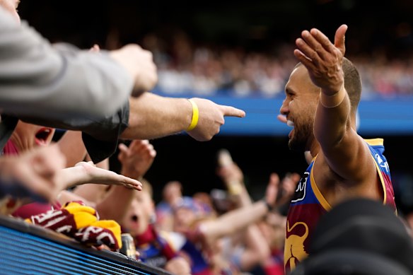 Callum Ah Chee of the Lions celebrates with fans.