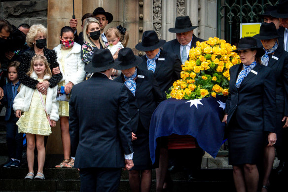 Bert Newton’s widow Patti and daughter Lauren look on as the TV icon’s casket leaves St Patrick’s Cathedral. 