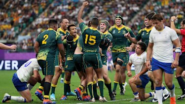 Better late than never: Slipper is swamped by teammates after crossing the stripe for the first time in Tests.