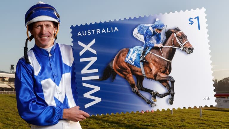 Stamp it: Jockey Hugh Bowman shows off the Winx stamp