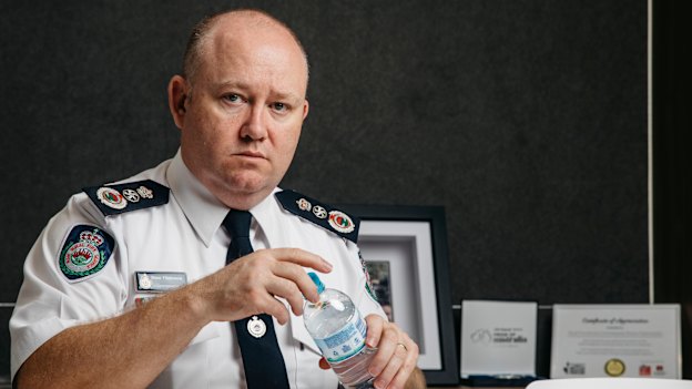 Shane Fitzsimmons in his office - with water bottle, a day when he's skipped lunch.