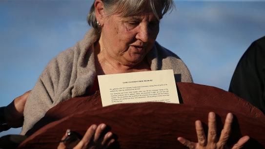 Pat Anderson from the Referendum Council with a piti holding the Uluru Statement from the Heart.