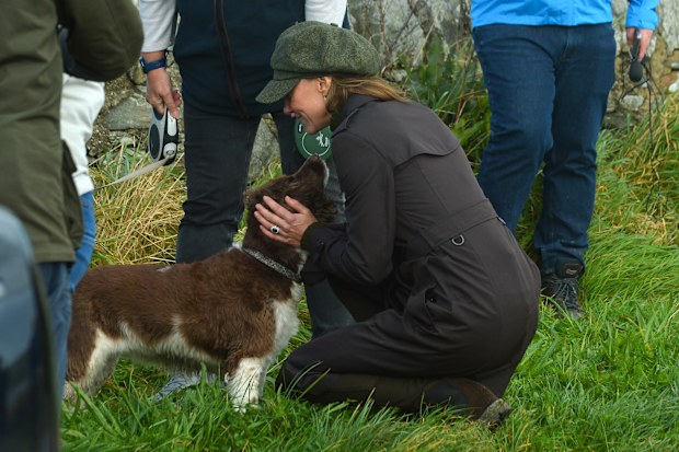 Catherine, Princess of Wales pets a dog during a royal visit to the Isle of Bute on September 17, 2026 in Rothesay, Isle of Bute, Scotland