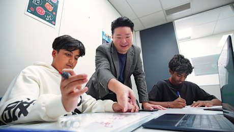 Chris Chau, founder of Integral Education tutoring, with Samyak Jain (left) and Maahir Deora.