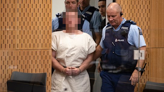 Brenton Harrison Tarrant is lead into the dock for his appearance where he was charged with murder.