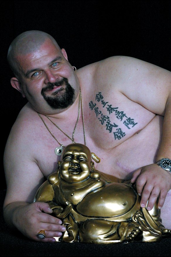 Sempai Big Bad Ralph, a martial arts instructor with a laughing Buddha, from the Feng Shui Network stand at the Mind Body Spirit festival.