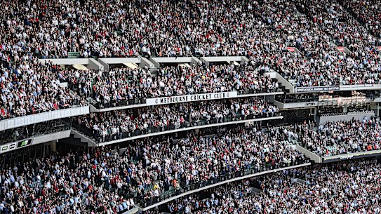 MELBOURNE, AUSTRALIA - APRIL 25: The crowd stands for a minute silence for Anzac Day during the round six AFL match between the Essendon Bombers and the Collingwood Magpies at Melbourne Cricket Ground on April 25, 2022 in Melbourne, Australia. (Photo by Quinn Rooney/Getty Images) .
