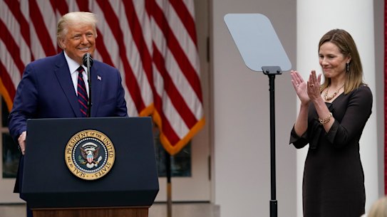 Judge Amy Coney Barrett applauds as President Donald Trump announces Barrett as his nominee.