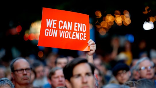 Mourners gather for a vigil at the scene of a mass shooting, Sunday, Aug. 4, 2019, in Dayton, Ohio. 