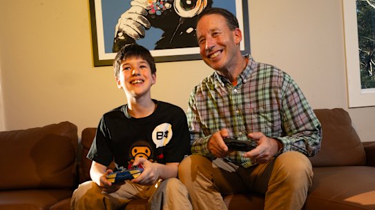 Mike Luzar (right) and his son Remy regularly play video games together. They’re part of a growing trend in Australia.