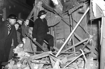 NES workers stand in the remains of the kitchen and laundry of a Bellevue Hill house, which had received a direct hit on June 8, 1942.