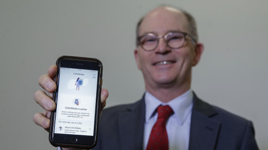 Deputy Chief Medical Officer Professor Paul Kelly poses with the COVIDSafe app downloaded to his mobile phone.