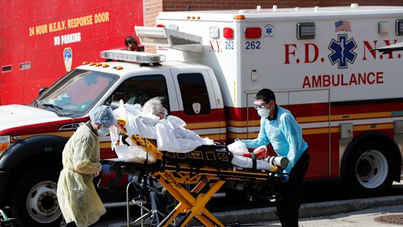 A patient is transferred to a waiting ambulance in New York. 