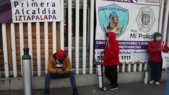People wait their turn to fill their tanks with oxygen, in Mexico City. The city offers free oxygen refills for COVID-19 patients. 