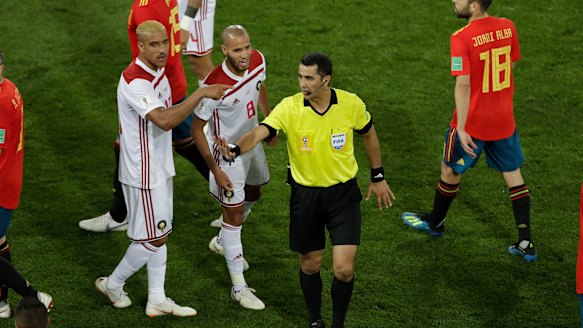 'Serious referee errors': Morocco's Karim El Ahmadi (8) talks to referee Ravshan Irmatov after the match between Spain and Morocco.