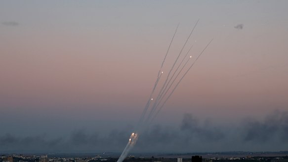 Palestinian rockets cross the sky after militants attack an Israeli bus with a mortar.