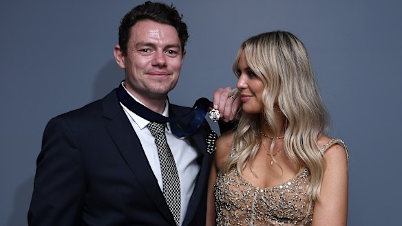 Lachie Neale of the Lions poses with his wife Jules after winning the Brownlow Medal.