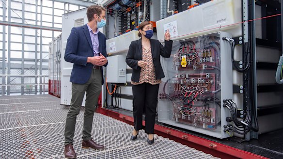 Scott Ferraro, program director, Net Zero Initiative showing batteries to Minister for Energy, Environment and Climate Change Lily D'Ambrosio. 