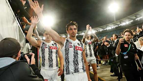 Collingwood captain Scott Pendlebury leads his teammates off the ground after the Magpies defeated Essendon.
