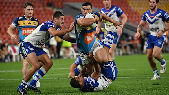 Titans star David Fifita crashes through the Bulldogs defence.