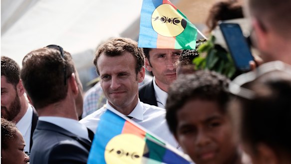 French President Emmanuel Macron is surrounded by independence Kanak flags on Ouvea Island, off New Caledonia, on Saturday, May 5.