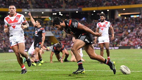 Over the line: Peta Hiku dots down for the Warriors.
