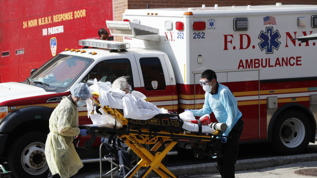 A patient is transferred to a waiting ambulance in New York. 