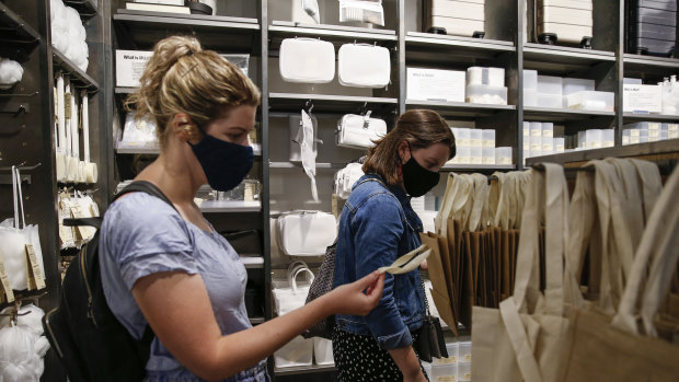 Customers wear face masks while shopping at a Muji store in Islington, London.