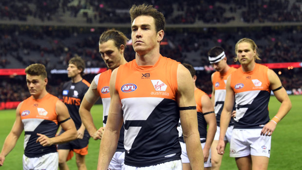 The Giants, led by Jeremy Cameron, trudge off after their loss to Essendon at Marvel Stadium on Thursday night.