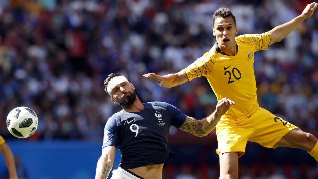 Rarefied air: Trent Sainsbury keeps French star Olivier Giroud honest during Australia's clash against Les Bleus.