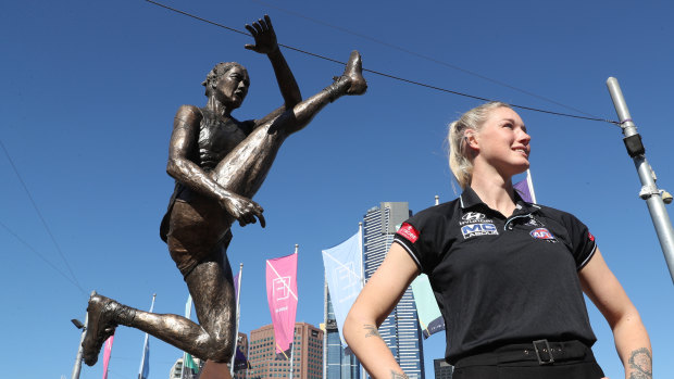 Tayla Harris poses with her statue in Federation Square.